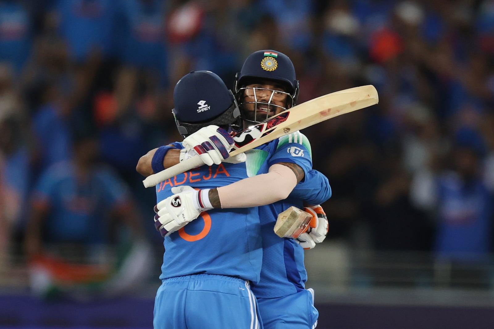 India's Ravindra Jadeja, left, hugs batting partner KL Rahul to celebrate their win in the ICC Champions Trophy final cricket match against New Zealand at Dubai International Cricket Stadium in Dubai, United Arab Emirates, Sunday, March 9, 2025. (AP Photo/Christopher Pike)