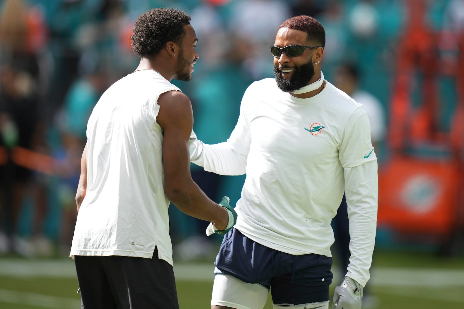 Miami Dolphins wide receiver Odell Beckham Jr. talks on the field before an NFL football game against the New York Jets, Sunday, Dec. 8, 2024, in Miami Gardens, Fla. (AP Photo/Lynne Sladky)