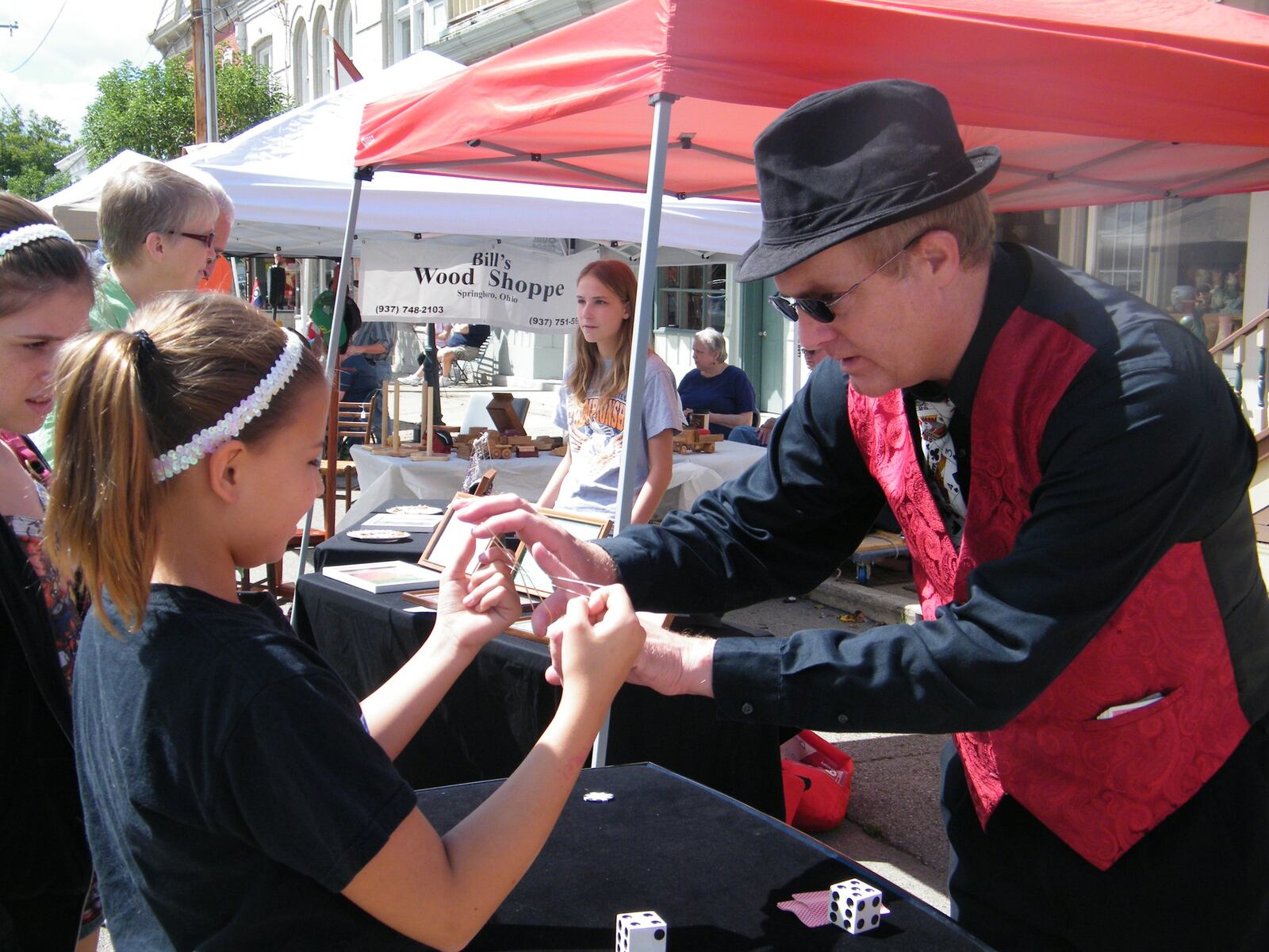 Street Magician Scott Miller wows attendees at last year’s Second Saturday Street Fair in Waynesville.