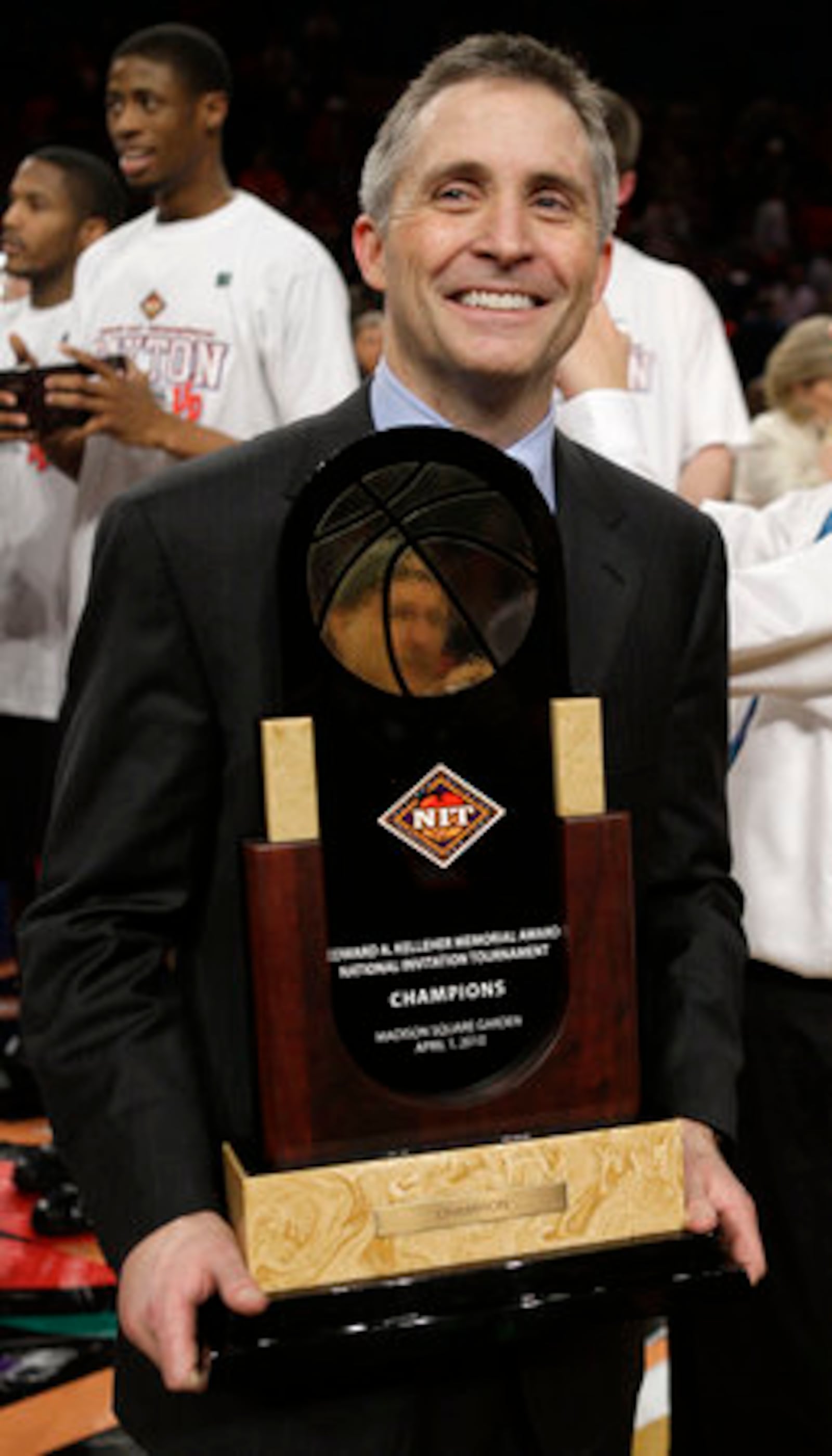 Dayton coach Brian Gregory holds the championship trophy after Dayton defeated North Carolina 79-68 in the NIT college basketball event Thursday, April 1, 2010, in New York.