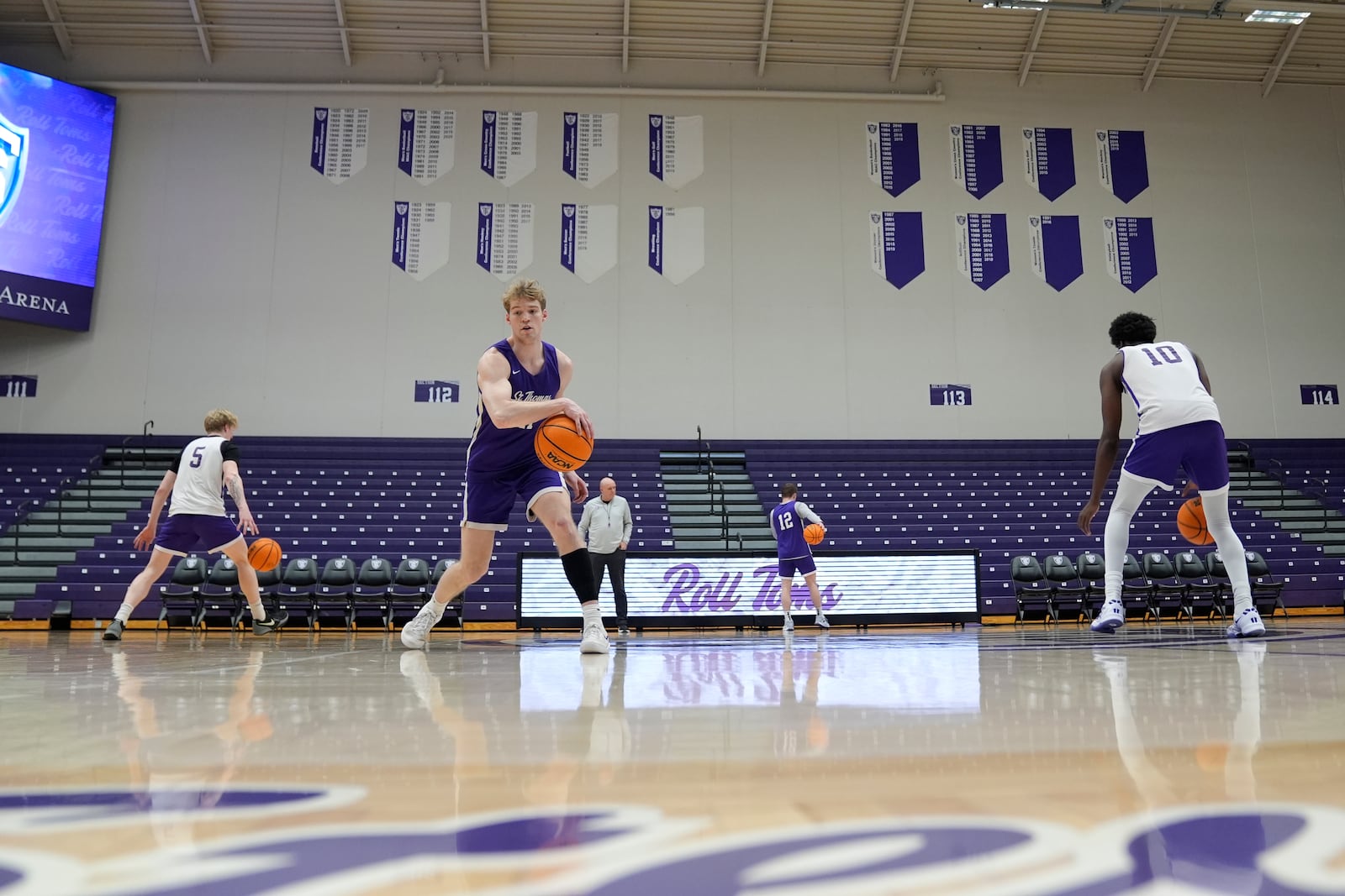 St. Thomas guard Drake Dobbs (11), left, takes part in drills during NCAA college basketball practice, Wednesday, Feb. 26, 2025, in St. Paul, Minn. (AP Photo/Abbie Parr)