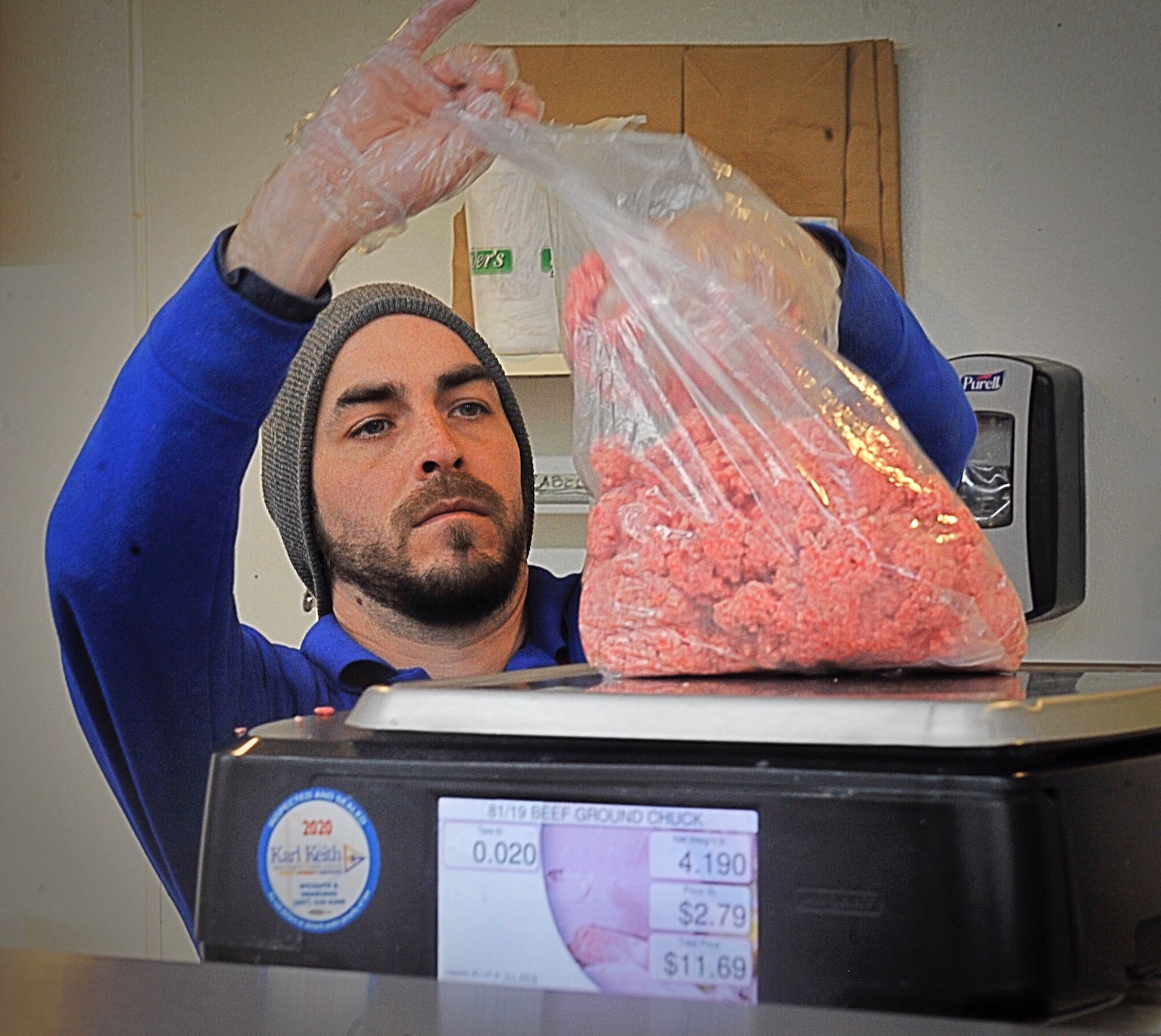 Dots Market employee, Geoffrey Pierce, fills a bag with fresh ground beef. The market takes great pride in having a very well stocked meat case. MARSHALL GORBYSTAFF