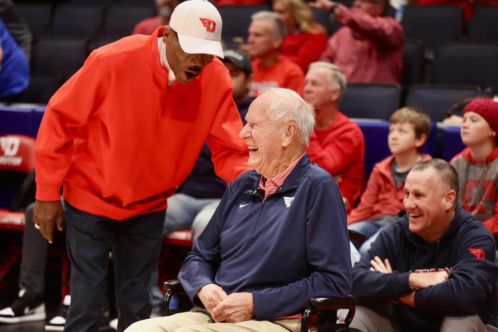 Roosevelt Chapman, left, talks to Don Donoher before a ceremony honoring members of Dayton's 1984 Elite Eight team at halftime of a game against Grambling State on Saturday, Dec. 2, 2023, at UD Arena. David Jablonski/Staff