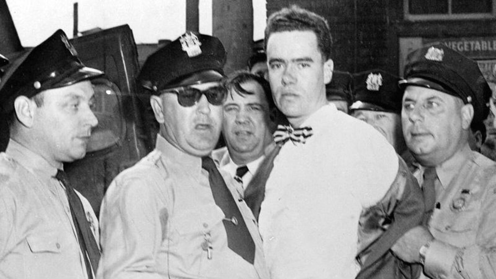 In this Sept. 6, 1949, photo, Howard Unruh, center, is pictured as police take him into custody for a mass shooting that killed 13 people. The 28-year-old World War II veteran targeted business owners and his neighbors in what is described as the first mass shooting in U.S. history.