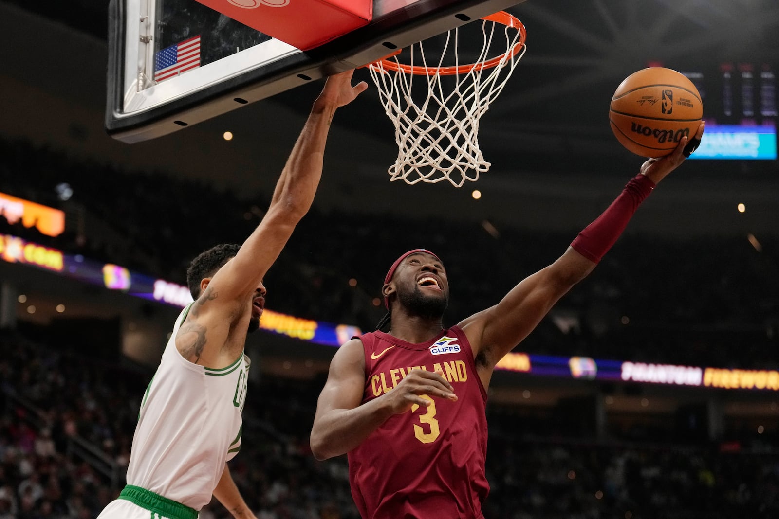 Cleveland Cavaliers guard Caris LeVert (3) shoots in front of Boston Celtics forward Jayson Tatum, left, in the first half of an NBA basketball game, Sunday, Dec. 1, 2024, in Cleveland. (AP Photo/Sue Ogrocki)