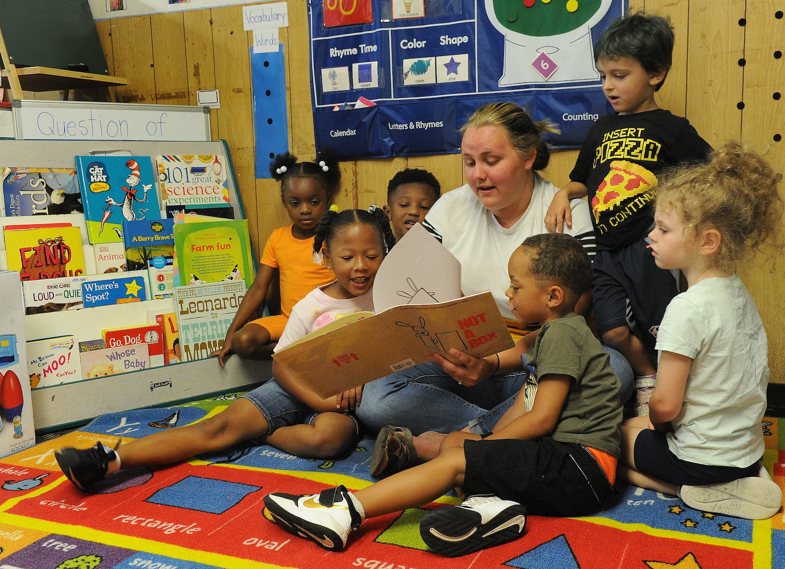 Breanna Sharp reads to her preschoolers Tuesday July 6, 2021 at the On Purpose Academy just north of downtown Dayton. Preschool Promise, which has served 4-year-olds in Dayton and Montgomery County for years, will now offer their services to 3-year-olds in the city of Dayton. MARSHALL GORBY\STAFF