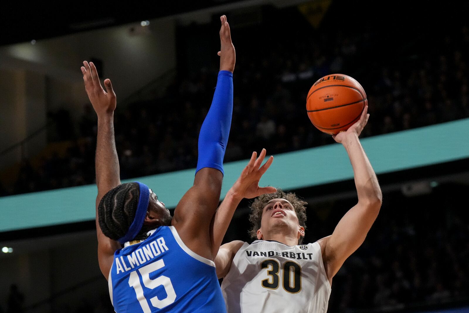 Vanderbilt guard Chris Manon (30) shoots the ball over Kentucky forward Ansley Almonor (15) during the first half of an NCAA college basketball game Saturday, Jan. 25, 2025, in Nashville, Tenn. (AP Photo/George Walker IV)