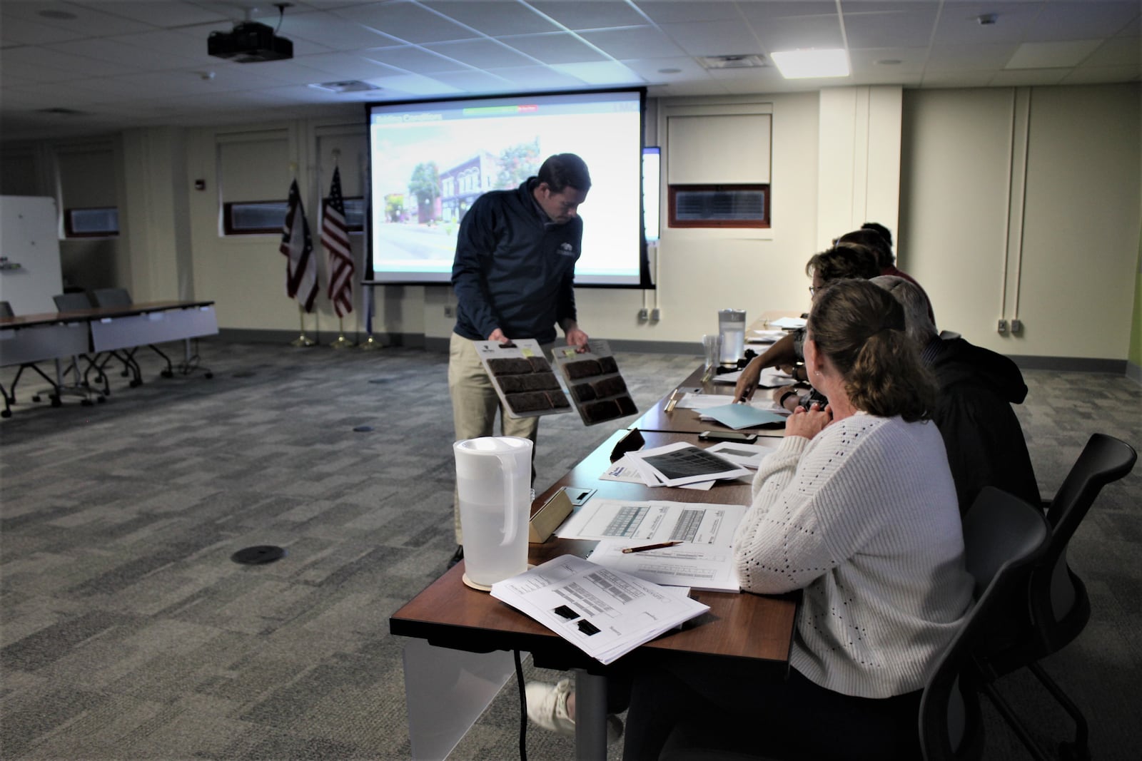 Robi Simms, vice president of Charles Simms Development, shows members of the Landmarks Commission examples of brick the company could use to build new townhomes in the Wright Dunbar neighborhood. CORNELIUS FROLIK / STAFF