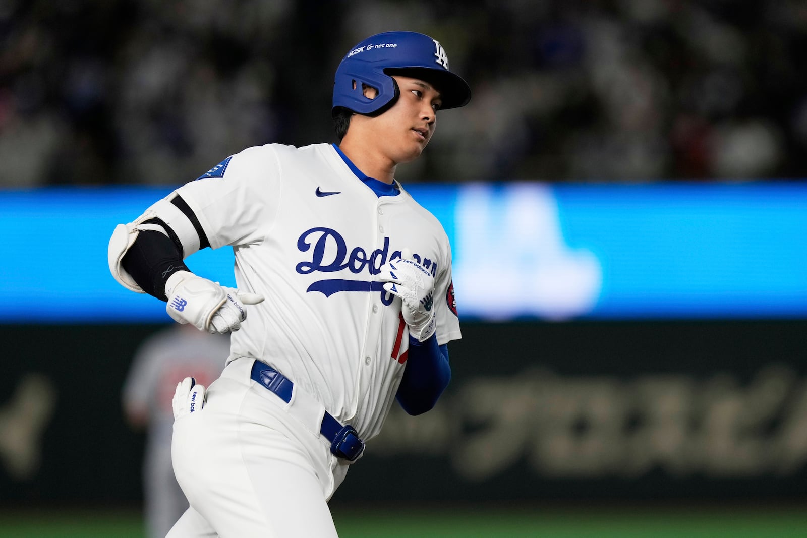 Los Angeles Dodgers' Shohei Ohtani rounds the bases after hitting a solo home run in the fifth inning of an MLB Tokyo Series baseball game against the Chicago Cubs in Tokyo, Japan, Wednesday, March 19, 2025. (AP Photo/Eugene Hoshiko)