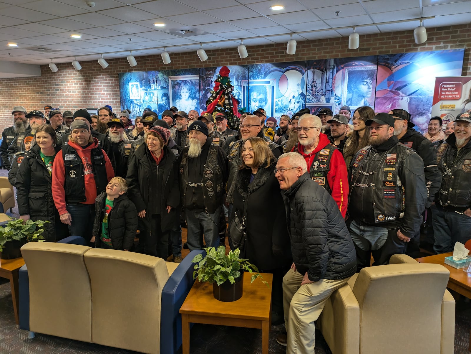 The Montgomery County commissioners pose with the Ohio State Coalition of Clubs (Ohio State COC) inside the Haines Children’s Center in Dayton after the motorcyclists delivered more than $10,000 in holiday presents to Montgomery County Children Services on Sunday, Dec. 1. Caseworkers will distribute gifts to children of all ages who are in Montgomery County’s care during the holidays. SAM WILDOW/STAFF