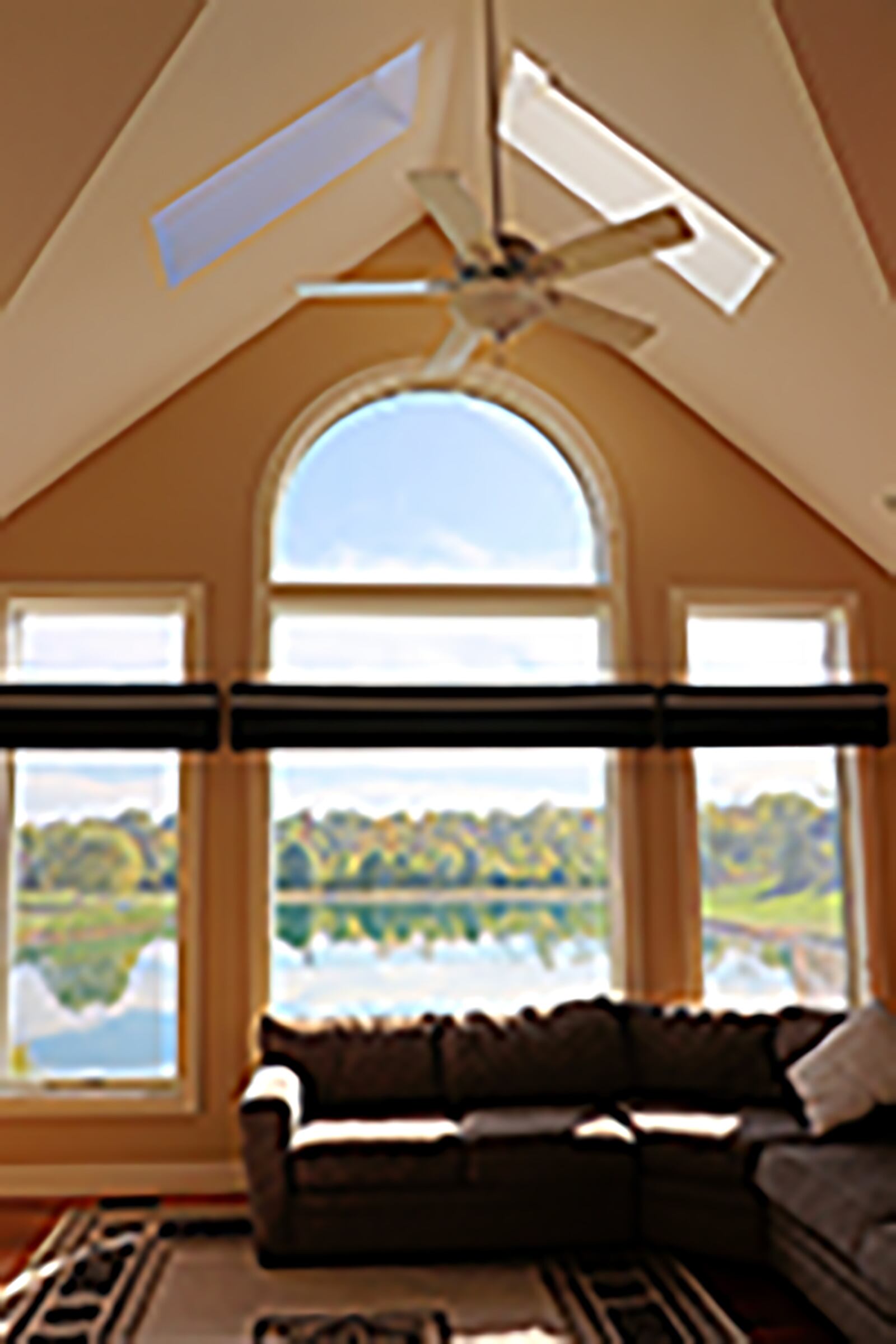 Palladian-style windows and two skylights fill the great room with natural light and provide picturesque views of the pond. CONTRIBUTED PHOTO BY KATHY TYLER