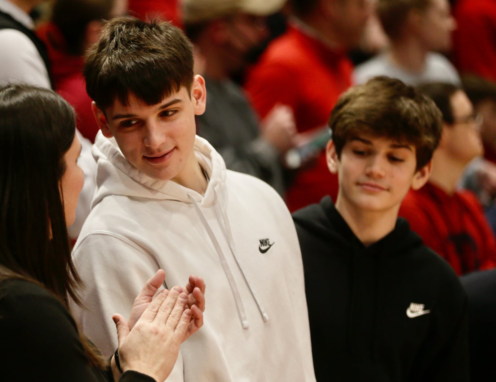 Nathan Dudukovich, a junior at Lakota West, watches Dayton's game against Duquesne from behind the bench on Wednesday, Feb. 9, 2022, at UD Arena. David Jablonski/Staff