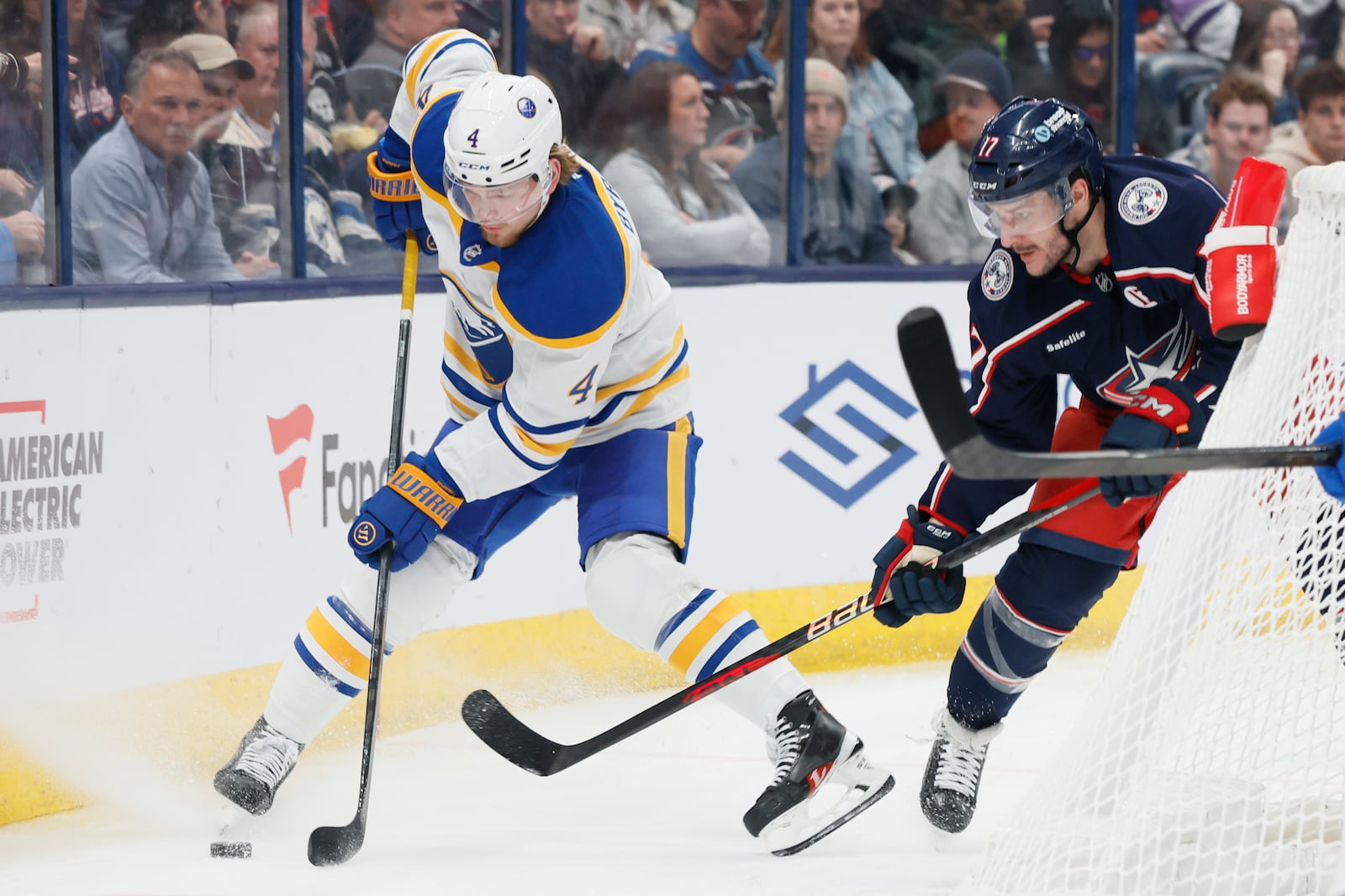 Buffalo Sabres' Bowen Byram, left, controls the puck as Columbus Blue Jackets' Justin Danforth, right, defends during the second period of an NHL hockey game Thursday, Oct. 17, 2024, in Columbus, Ohio. (AP Photo/Jay LaPrete)