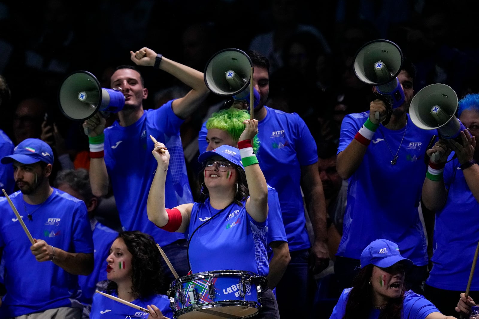 Italy supporters cheer during the match between Jannik Sinner and Argentina's Sebastian Baez during a Davis Cup quarterfinal match at the Martin Carpena Sports Hall in Malaga, southern Spain, on Thursday, Nov. 21, 2024. (AP Photo/Manu Fernandez)