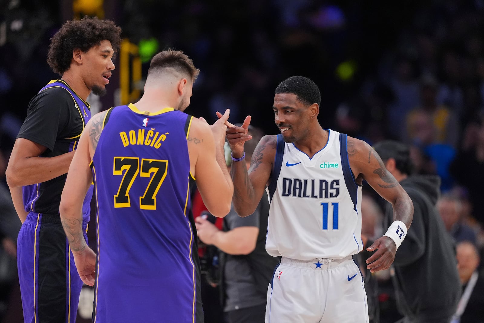 Los Angeles Lakers guard Luka Doncic (77) and Dallas Mavericks guard Kyrie Irving (11) shake hands before an NBA basketball game Tuesday, Feb. 25, 2025, in Los Angeles. (AP Photo/Mark J. Terrill)