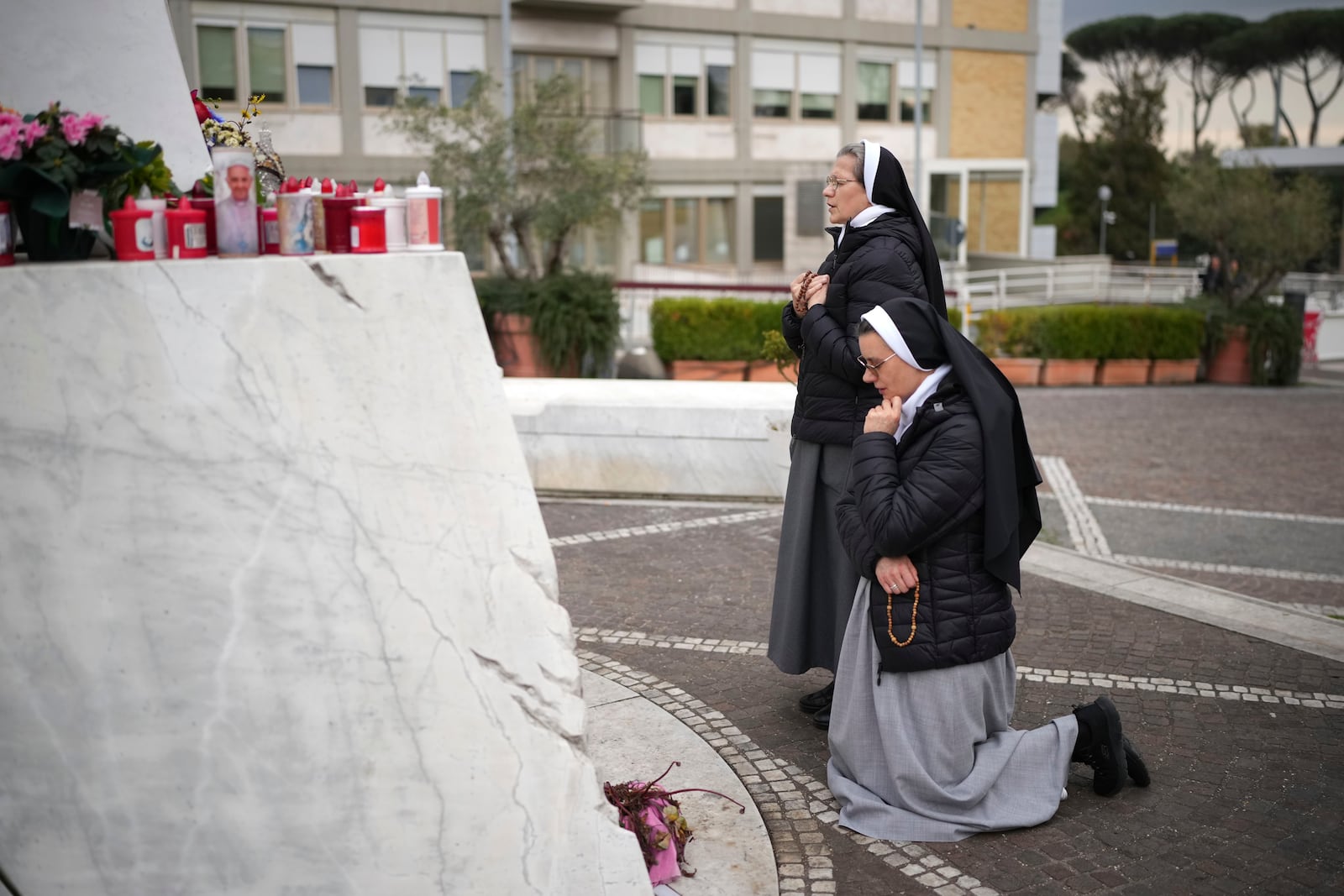 Nuns pray for Pope Francis in front of the statue of Pope John Paul II at the Agostino Gemelli Polyclinic, in Rome, Thursday, Feb. 20, 2025, where the Pontiff is hospitalized since Friday, Feb. 14.(AP Photo/Alessandra Tarantino)