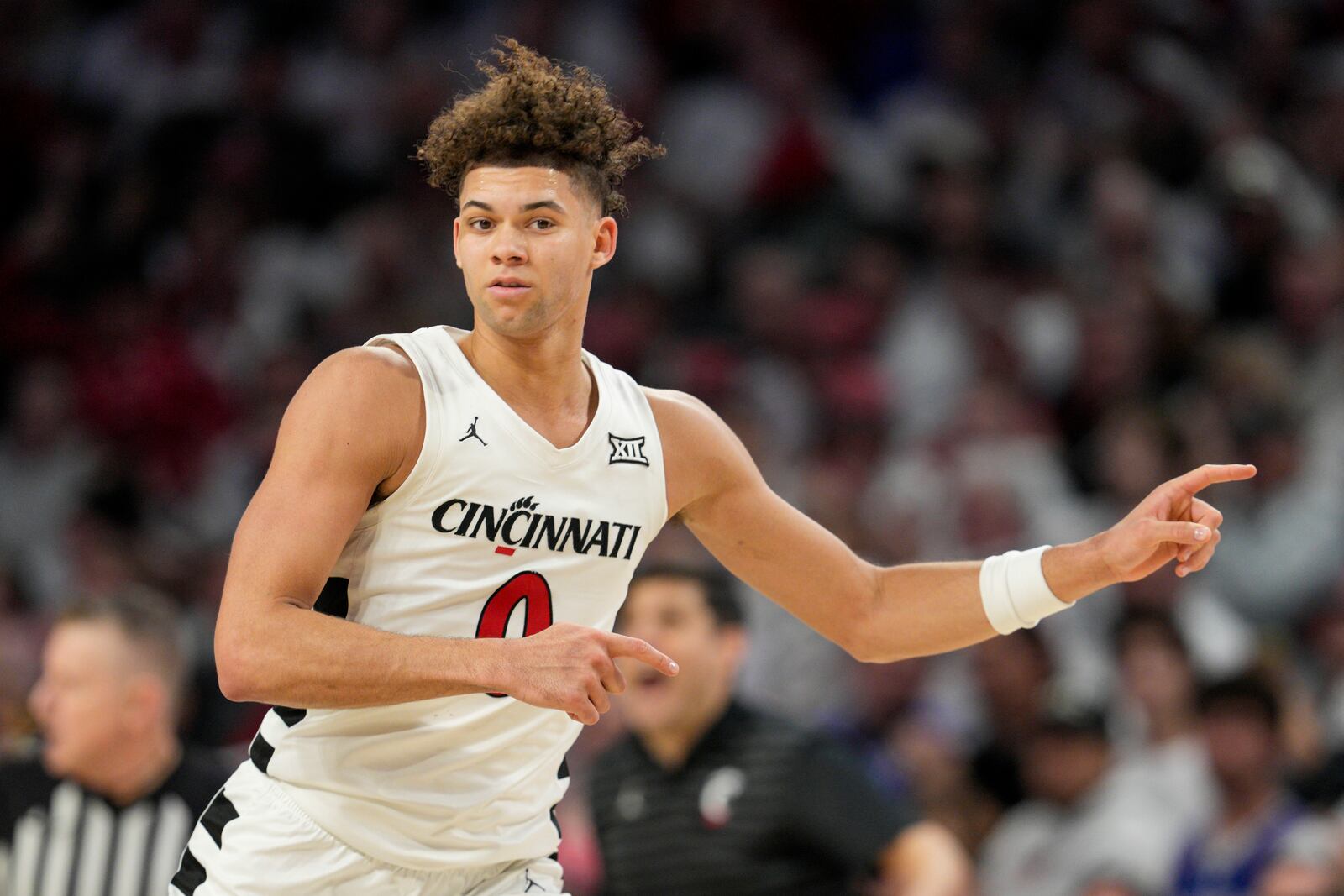 Cincinnati guard Dan Skillings Jr. (0) reacts after scoring during the second half of an NCAA college basketball game against Kansas, Saturday, Jan. 11, 2025, in Cincinnati. (AP Photo/Jeff Dean)