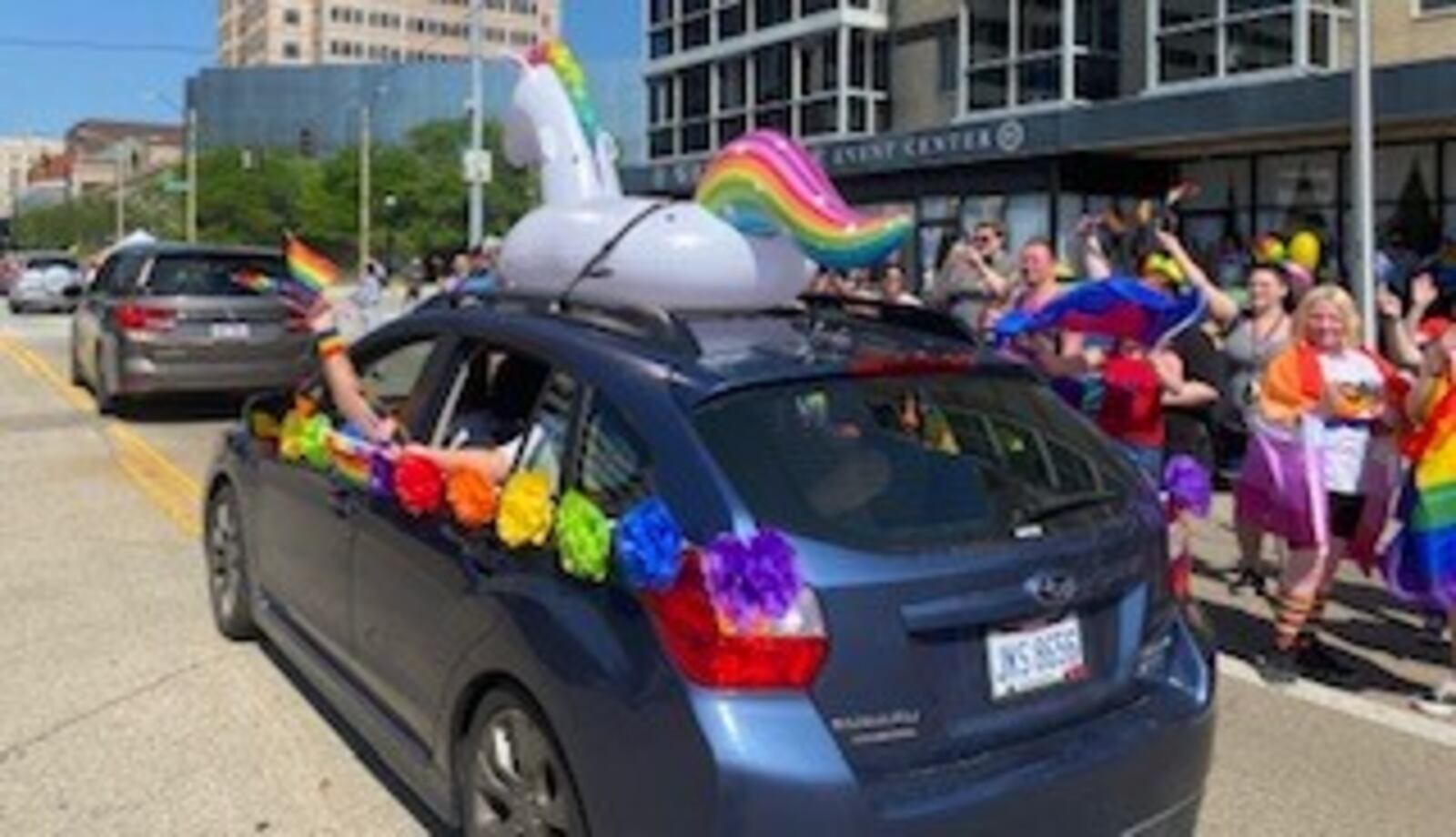 Pride celebrations were well underway at the Greater Dayton LGBT Center reverse parade on Saturday on East Second Street. Cars were decked out in bright colors, adorned with rainbow flags and hearts. In the air there were bubbles, car horns and chants of "love is love." Community allies passed out candy, snacks, and informational brochures to participants. The parade was followed by an LGBTQ+ Pride Festival at Courthouse Square.