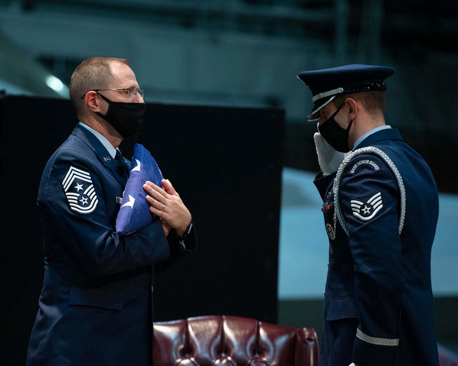 Chief Master Sgt. Stanley Cadell (left), Air Force Materiel Command command chief, is saluted by a Wright-Patterson Air Force Base Honor Guard member during his retirement ceremony Oct. 1 in the National Museum of the U.S. Air Force. U.S. AIR FORCE PHOTO/R.J. ORIEZ