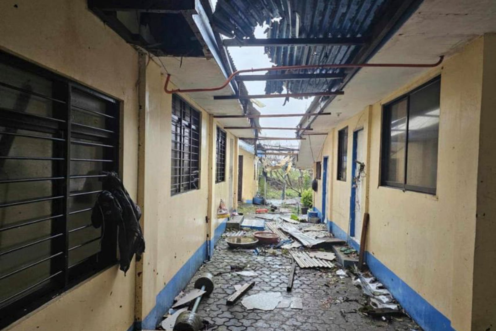 In this photo provided by the Provincial Disaster Risk Reduction and Management Office Cagayan, debris from damaged roof caused by Typhoon Yinxing are scattered beside an establishment in Sanchez Mira, Cagayan province, northern Philippines Friday Nov. 8, 2024. (Provincial Disaster Risk Reduction and Management Office, Cagayan via AP)