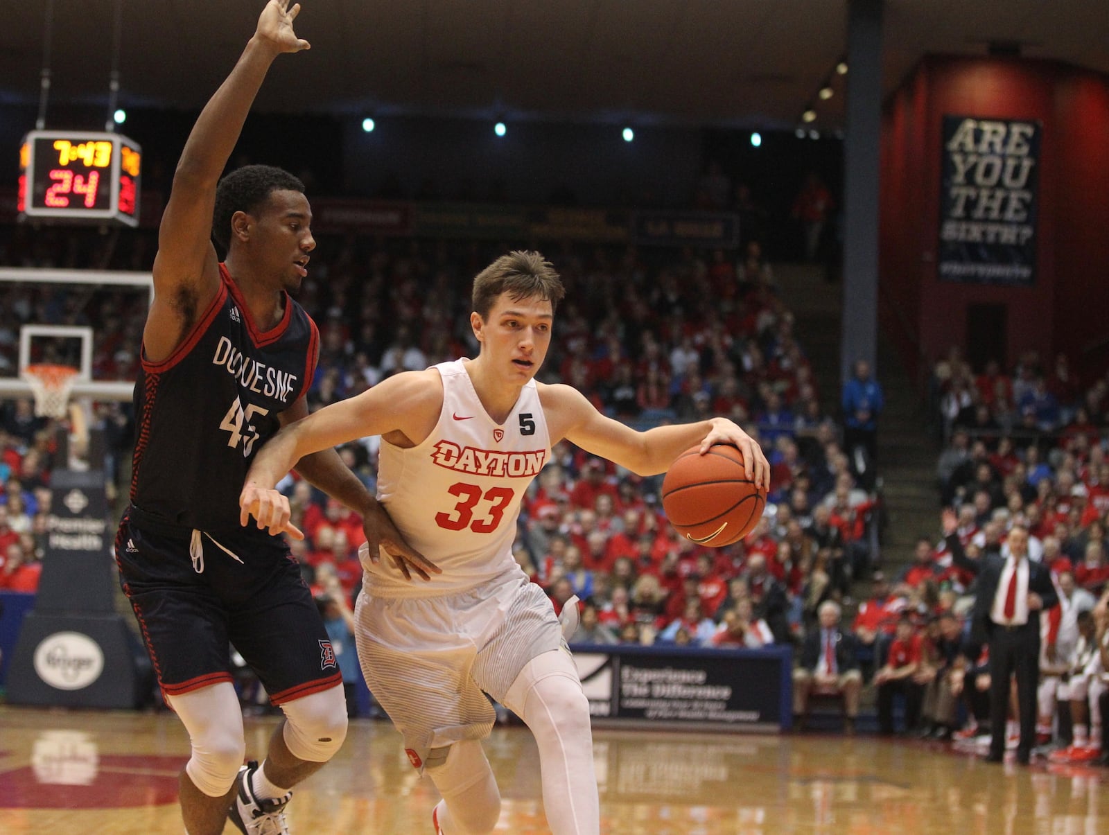 Dayton’s Ryan Mikesell dribbles against Duquesne’s Isiaha Mike on Saturday, Feb. 4, 2017, at UD Arena. David Jablonski/Staff