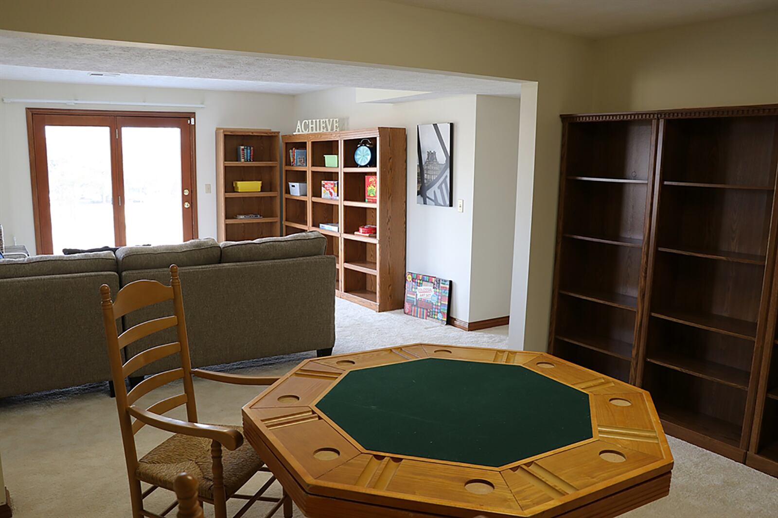 In the lower level, a recreation room is divided into a game room and media room. There is a daylight window and patio doors that open to a paver-brick patio and the back yard. CONTRIBUTED PHOTO BY KATHY TYLER