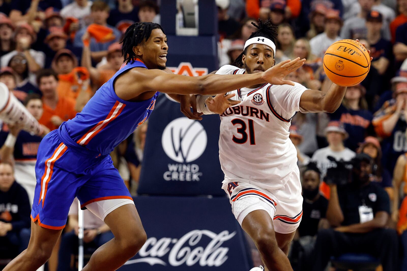 Florida forward Sam Alexis, left, and Auburn forward Chaney Johnson (31) battle for the ball during the second half of an NCAA college basketball game, Saturday, Feb. 8, 2025, in Auburn, Ala. (AP Photo/Butch Dill)