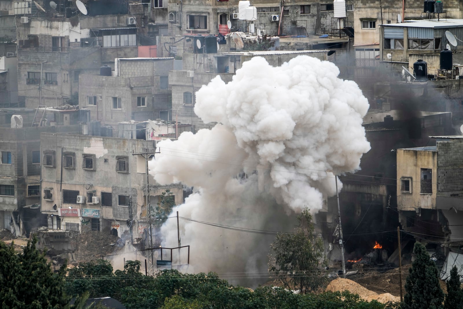 Israeli soldiers detonate an explosive device during a military raid in the West Bank refugee camp of Nur Shams, Tulkarem, Sunday, Feb. 9, 2025. (AP Photo/Majdi Mohammed)