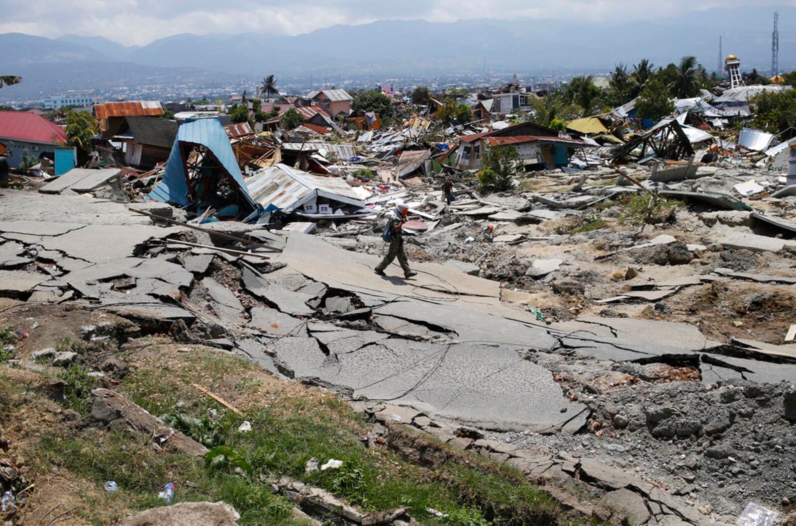 A man walks through the Balaroa neighborhood in Palu, Central Sulawesi, Indonesia, on Oct. 2, 2018, four days after a massive earthquake struck the region. 