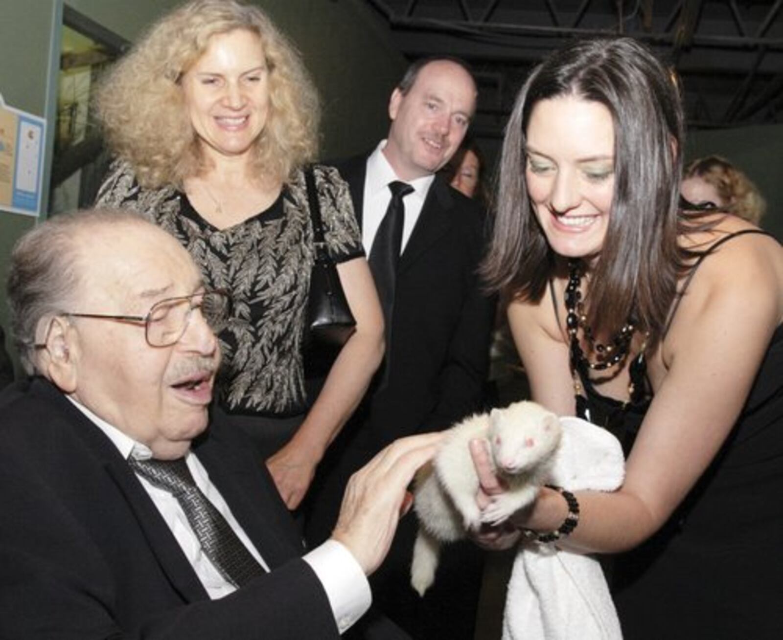 With daughter Linda, and Jeff Moore watching, Natalie Zinck holds Iggy the Ferrett for Oscar Boonshoft during the 2007 Boonshoft Gala, Saturday, September 8, 2007.