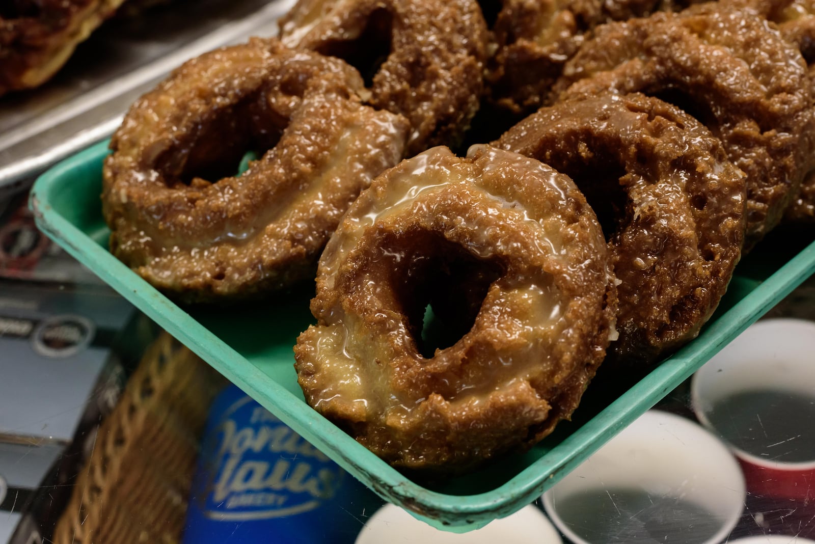 Happy National Donut Day! Here's a look behind-the-scenes of the donut making process at Bear Creek Donuts in Miamisburg and The Donut Haus Bakery in Springboro. Top sellers at Bear Creek Donuts are apple fritters and yeast rings (sprinkled with Oreo, Fruity Pebbles or maple bacon). Apple fritters and sour cream donuts are the top sellers at The Donut Haus Bakery. National Donut Day was started in 1938 by the Salvation Army to honor their Salvation Army Donut Lassies aka Donut Girls, volunteers who made fresh donuts during World War I for American soldiers serving in France. TOM GILLIAM / CONTRIBUTING PHOTOGRAPHER