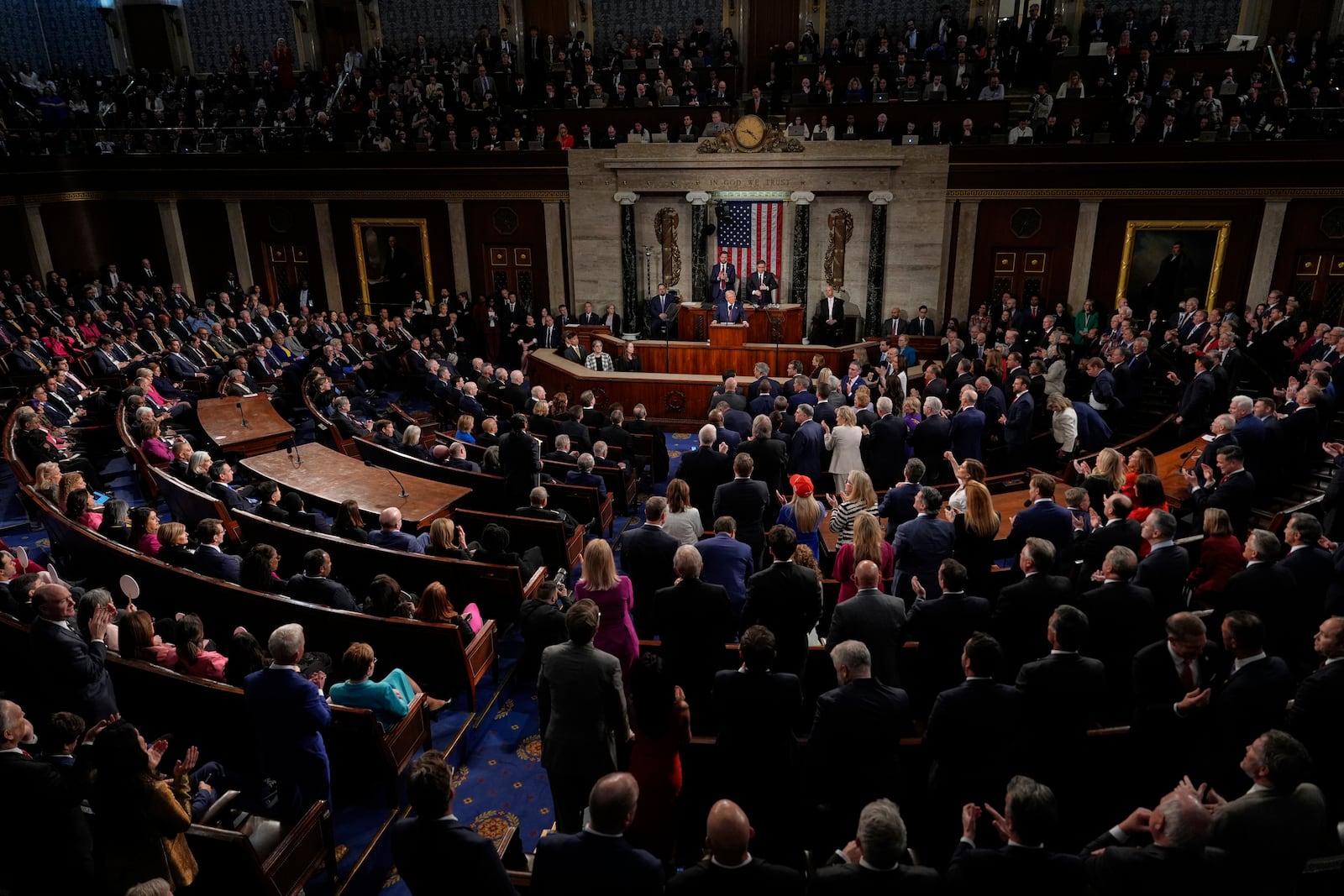 Republicans stand as Democrats sit as President Donald Trump addresses a joint session of Congress in the House chamber at the U.S. Capitol in Washington, Tuesday, March 4, 2025. (AP Photo/Julia Demaree Nikhinson)