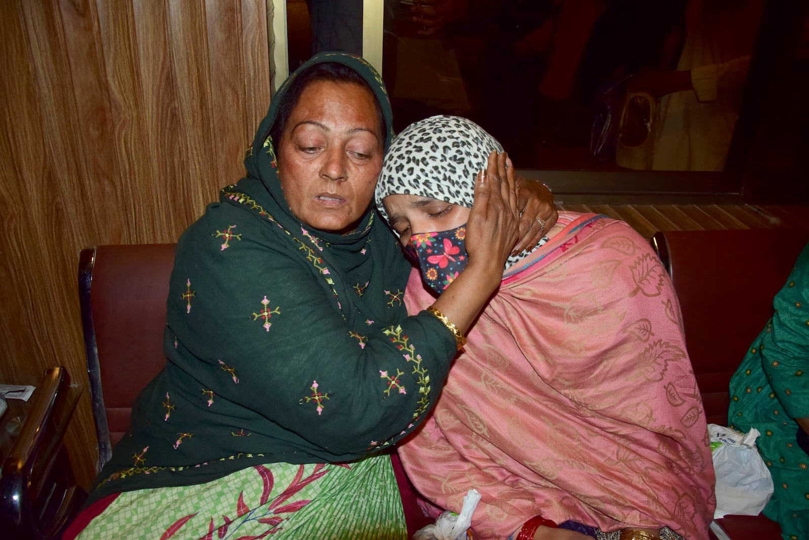 Passengers rescued by security forces from a passenger train attacked by insurgents comfort each other upon their arrival at a railway station in Quetta, Pakistan, Wednesday, March 12, 2025. (AP Photo/Arshad Butt)