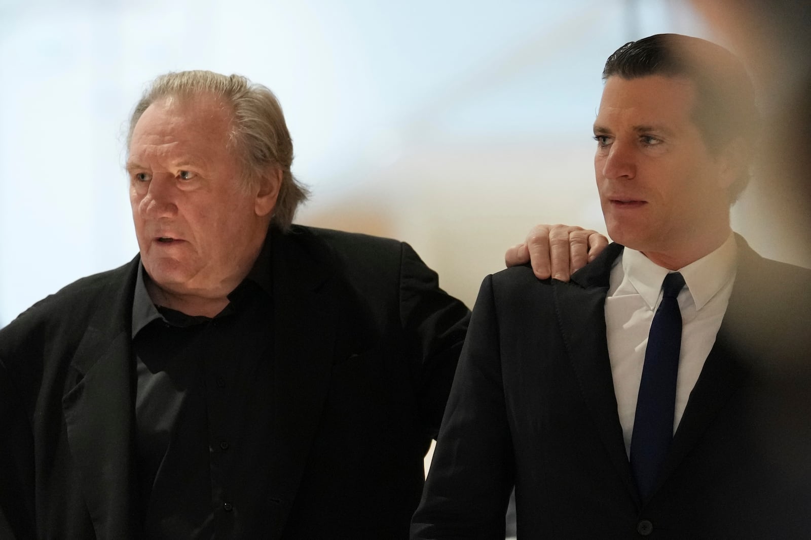 Actor Gerard Depardieu, left, arrives at his trial for the alleged sexual assaults of two women on a film set in 2021, with his lawyer Jeremie Assous ,Tuesday, March 25, 2025 in Paris. (AP Photo/Aurelien Morissard)