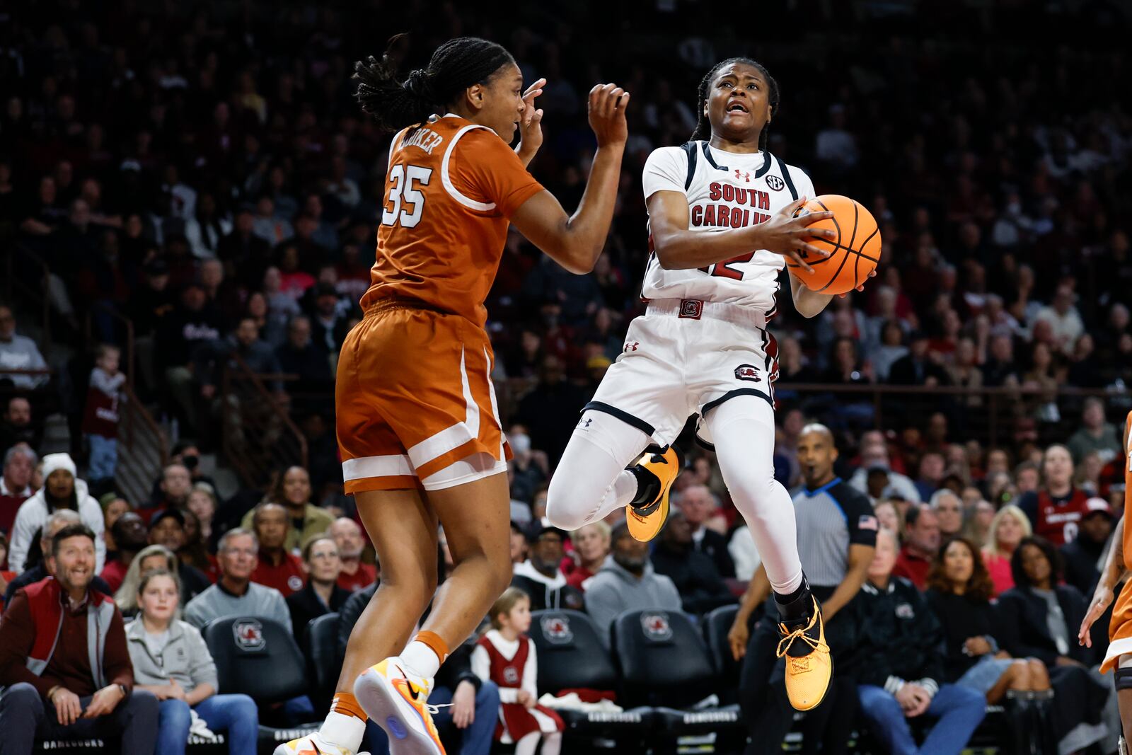 South Carolina guard MiLaysia Fulwiley, right, drives to the basket against Texas forward Madison Booker during the first half of an NCAA college basketball game in Columbia, S.C., Sunday, Jan. 12, 2025. (AP Photo/Nell Redmond)