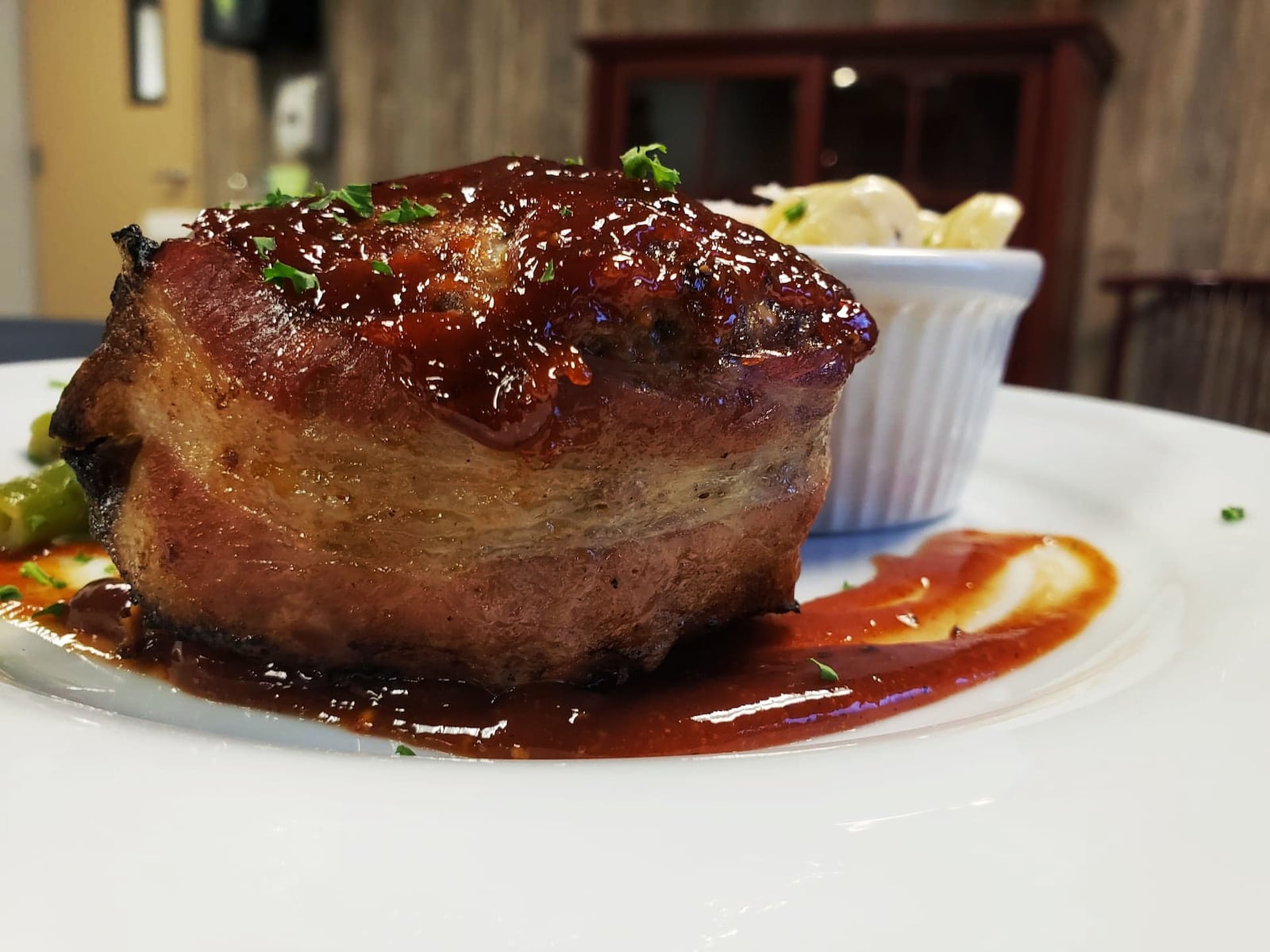 The Surf and Turf Meatloaf Dinner is one of the entrees offered on The Bison & The Boar's new comfort food menu.  The meatloaf is bacon-wrapped and served with lobster mac and cheese and country-style green beans. CONTRIBUTED