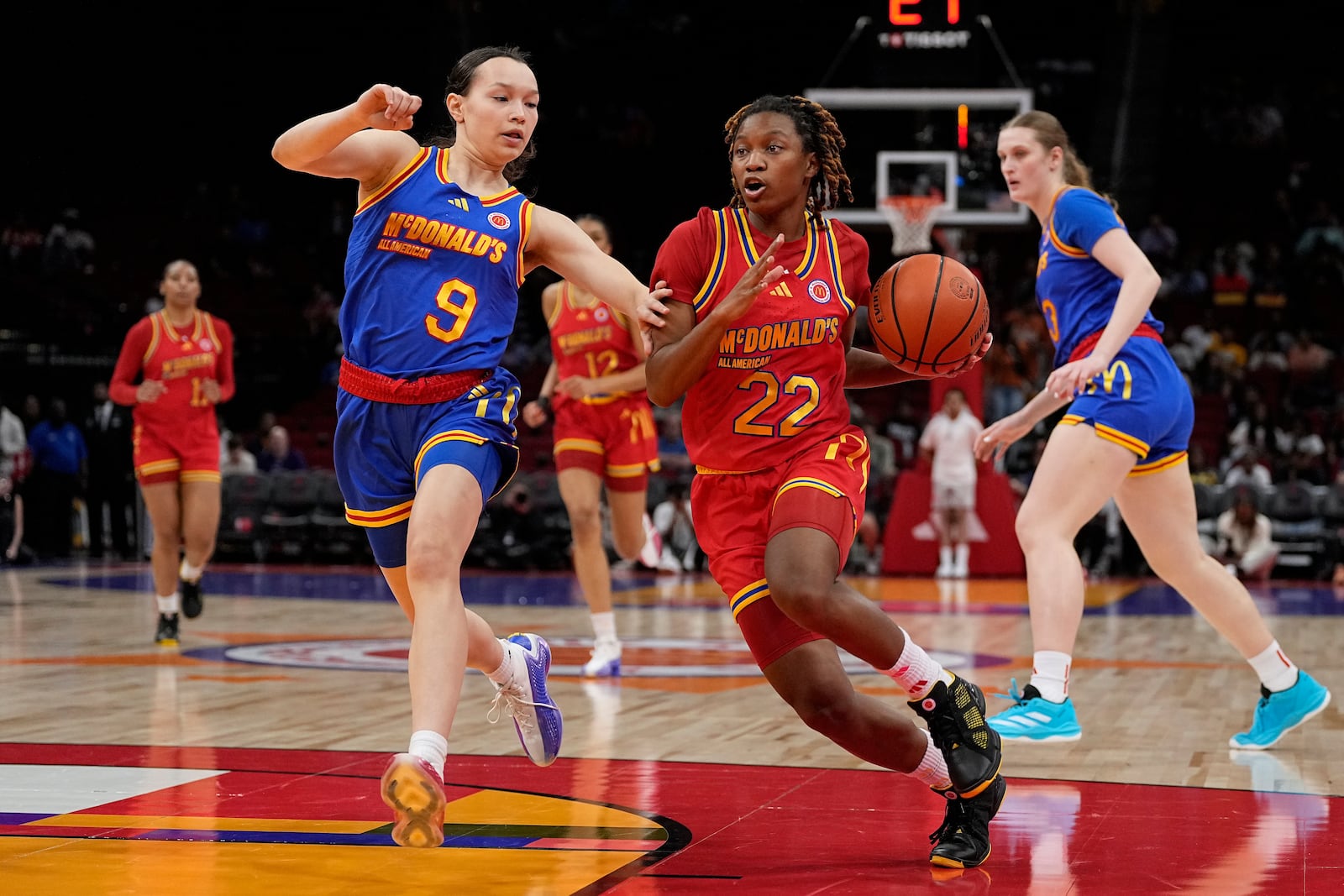 FILE - East guard Kayleigh Heckel (9) defends West guard Jaloni Cambridge (22) during the first quarter of the McDonald's All American girl's basketball game, April 2, 2024, in Houston. (AP Photo/Kevin M. Cox, File)