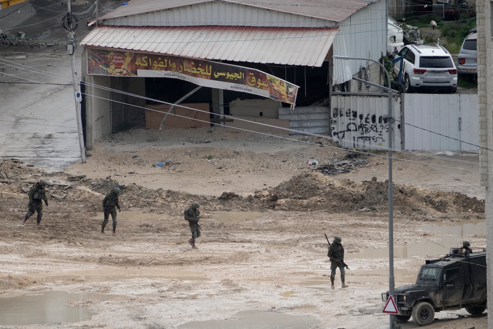 Israeli forces move through the West Bank Nur Shams refugee camp during an ongoing military operation on Wednesday, Feb. 12, 2025. (AP Photo/Majdi Mohammed)