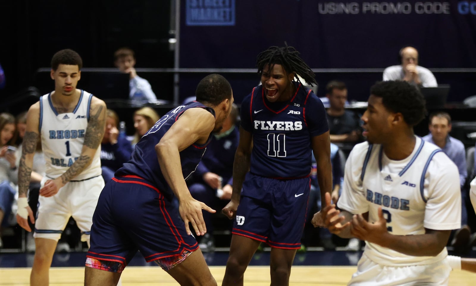 Dayton's Malachi Smith, center, reacts after a dunk by Zed Key in the first half against Rhode Island on Wednesday, Feb. 26, 2025, at the Ryan Center in Kingston, R.I. David Jablonski/Staff