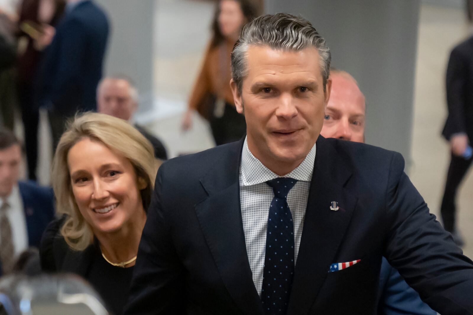 Pete Hegseth, President-elect Donald Trump's nominee to be defense secretary, is joined by his wife Jennifer Rauchet, as they walk through the basement of the Capitol, Wednesday, Dec. 4, 2024, in Washington. (AP Photo/Mark Schiefelbein)