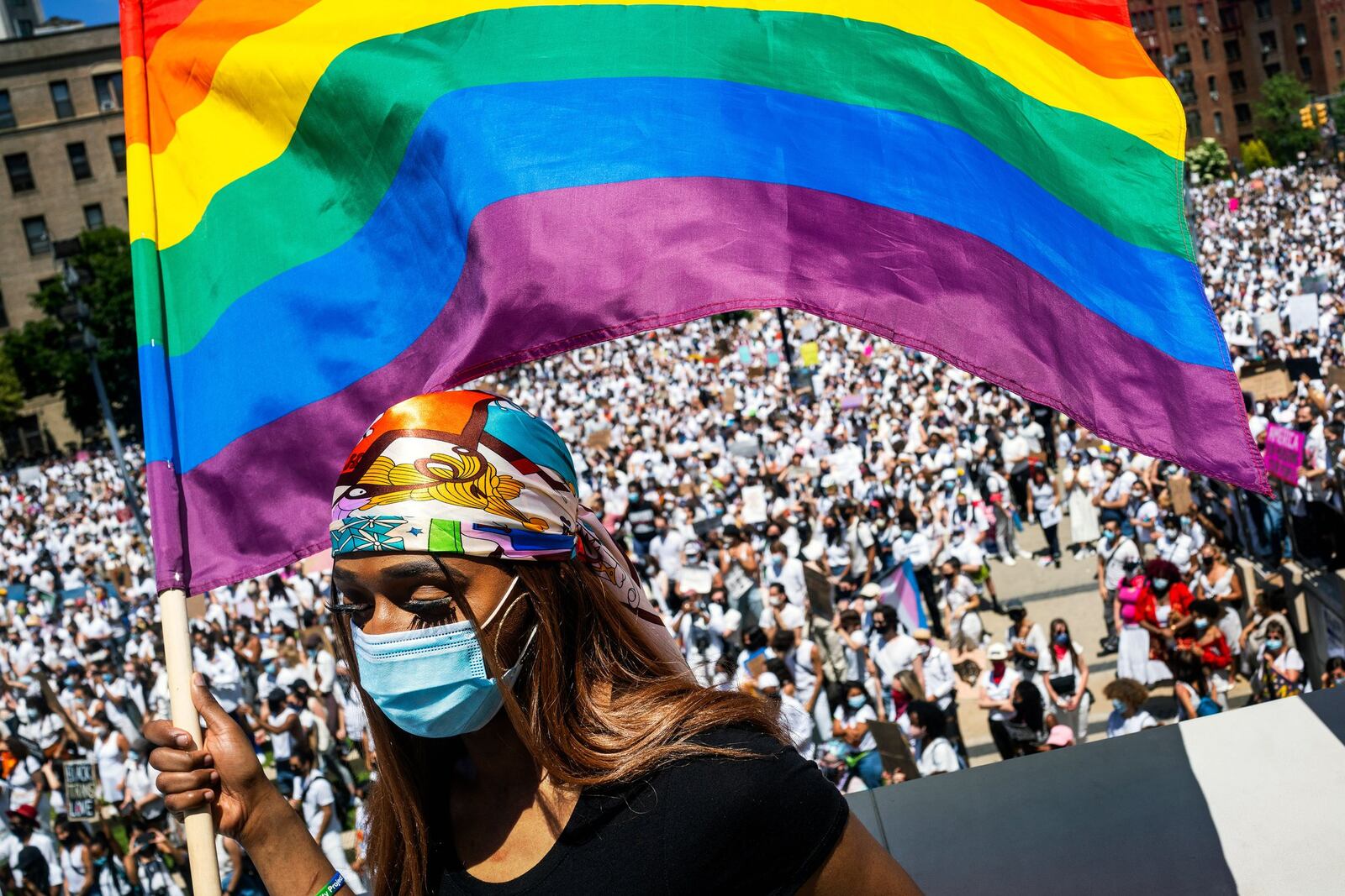 Tiffany Munroe waves a Pride flag during a rally to call attention to violence against transgender people of color in Brooklyn on Sunday, June 14, 2020. The Supreme Court ruled Monday, June 15, 2020, that a landmark civil rights law protects gay and transgender workers from workplace discrimination, handing the movement for LGBT equality a stunning victory. (Demetrius Freeman/The New York Times)