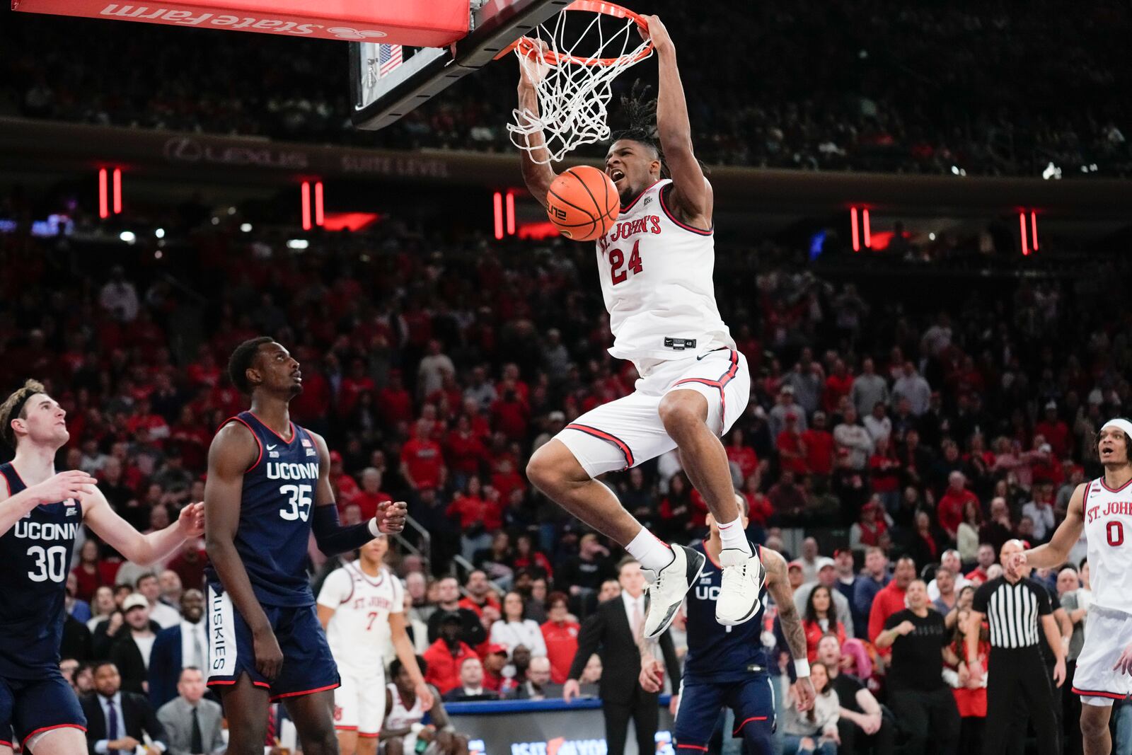 St. John's Zuby Ejiofor (24) dunks during the second half of an NCAA college basketball game against UConn, Sunday, Feb. 23, 2025, in New York. (AP Photo/Seth Wenig)