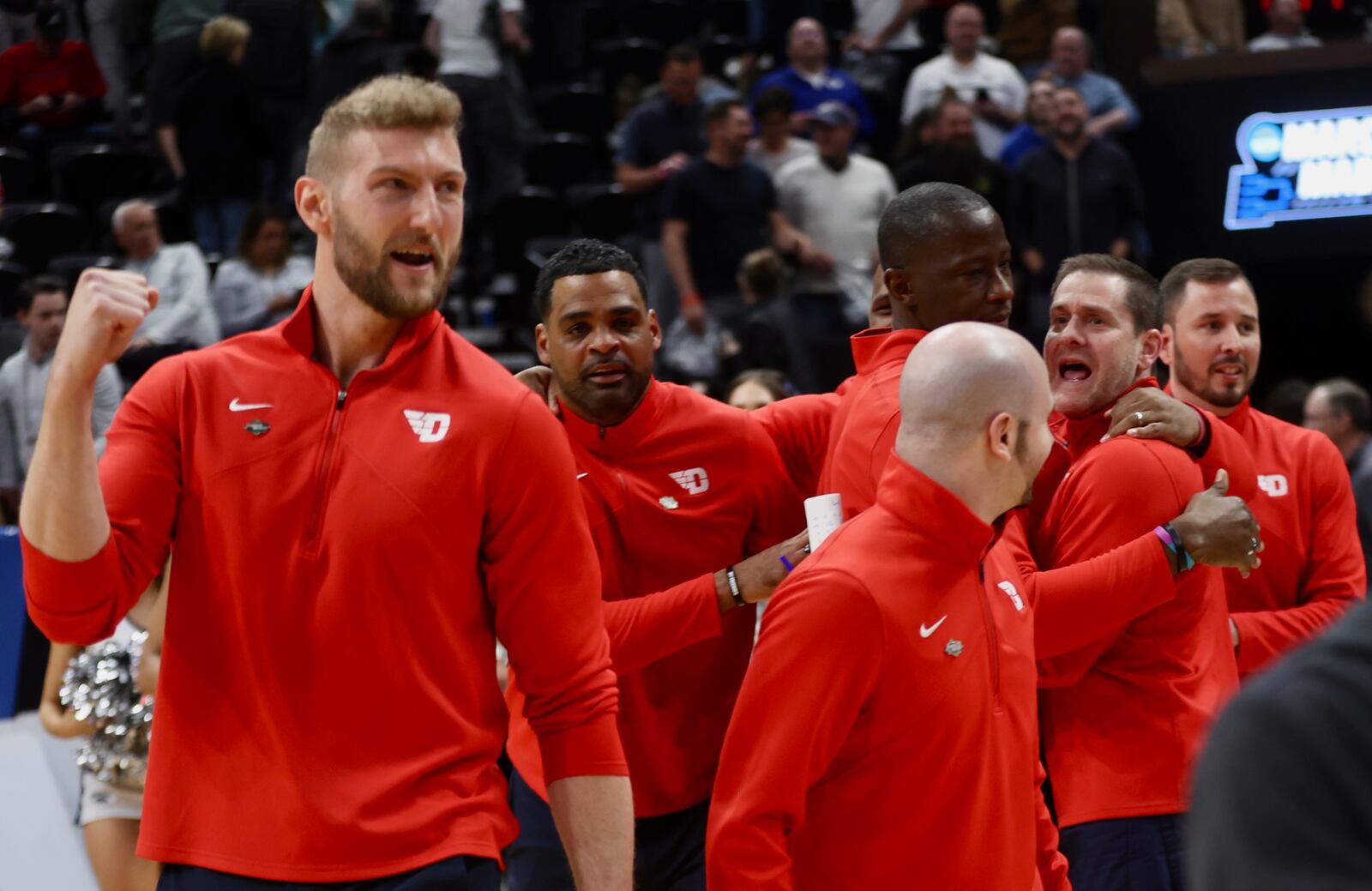 Dayton coaches celebrate after a victory against Nevada in the first round of the NCAA tournament on Thursday, March 21, 2024, at the Delta Center in Salt Lake City, Utah. David Jablonski/Staff