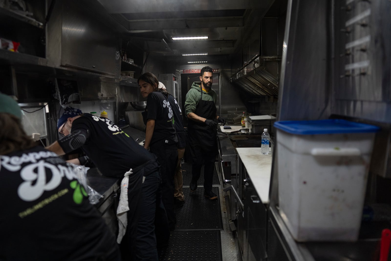 World Central Kitchen Chef Corp member Daniel Shemtob, right, and his team prepare burritos in his food truck, The Lime Truck, for Eaton Fire first responders at the Rose Bowl Stadium, Wednesday, Jan. 15, 2025, in Pasadena, Calif. (AP Photo/Carolyn Kaster)