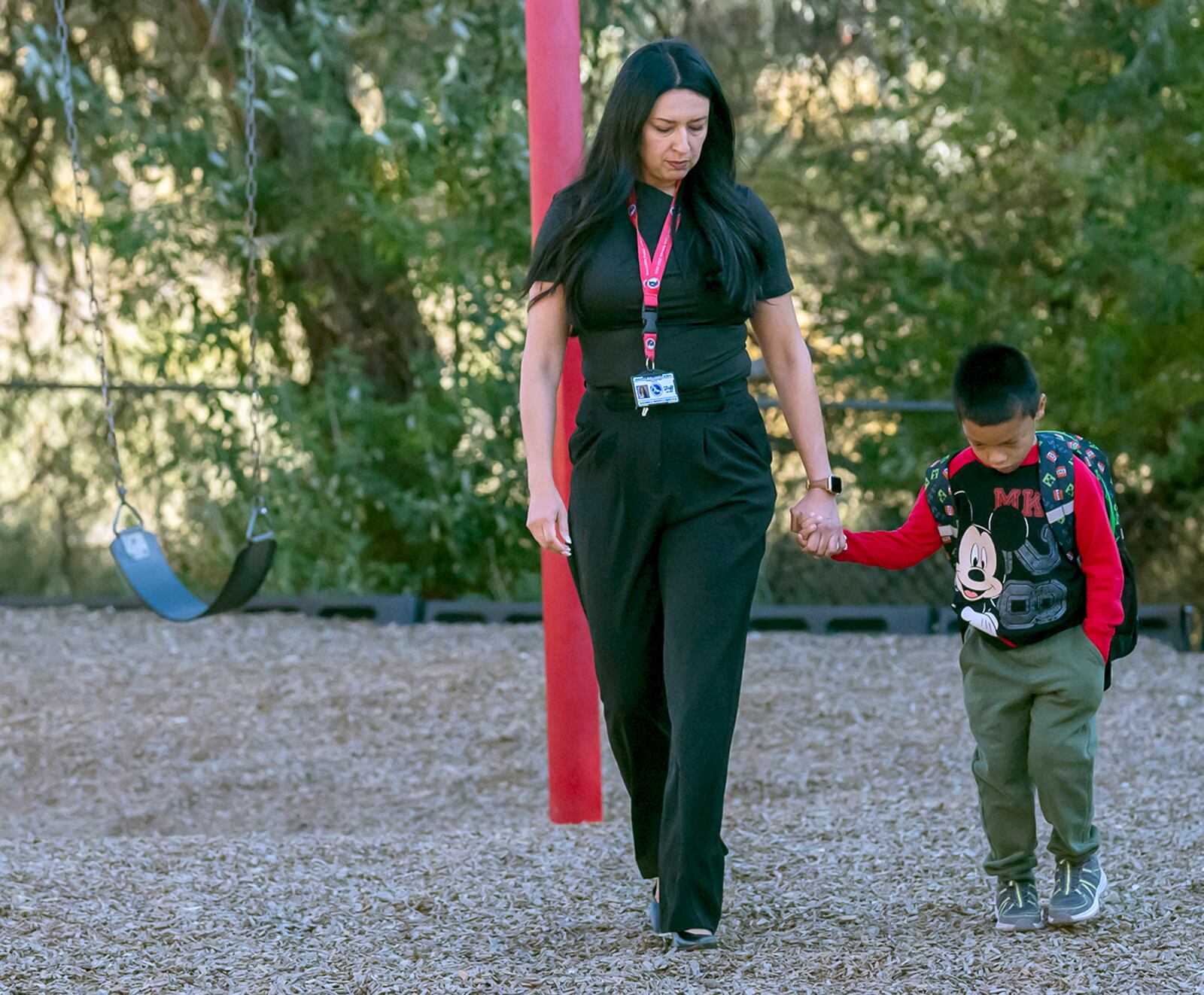 Principal Rosangela Montoya walks Jahim Chavez, 7, back into the school from the playground, Tuesday, Oct. 1, 2024, at Algodones Elementary School in Algodones, N.M. (AP Photo/Roberto E. Rosales)