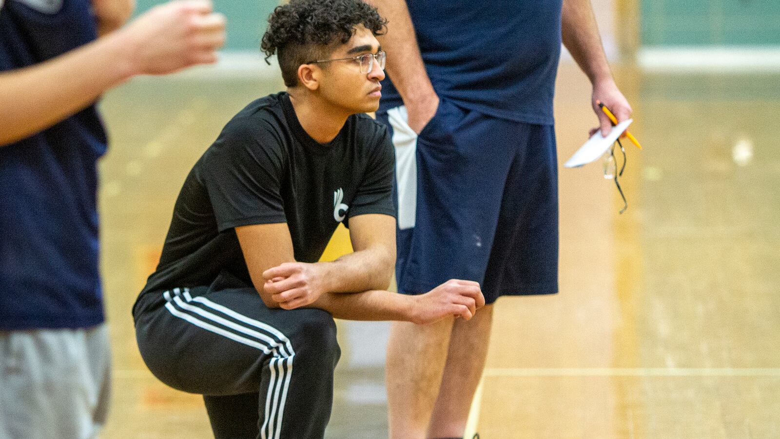 Fairmont student coach Jordan Harbeck watches a recent practice. Harbeck works with the team at practice, breaks down film with the players and sits on the bench during games. Jeff Gilbert/CONTRIBUTED