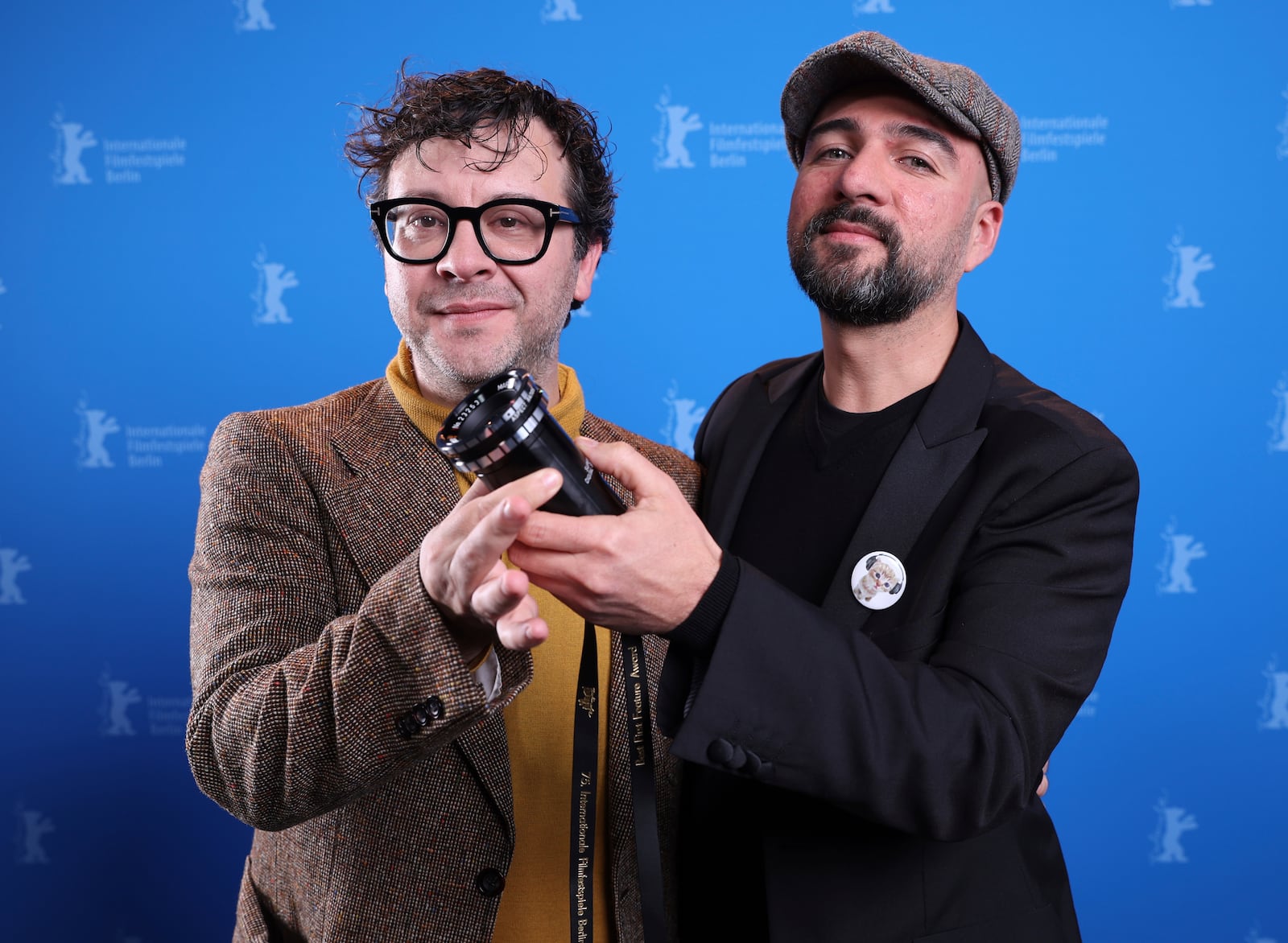 Mexican director Ernesto Martinez Bucio, right, and producer Alejandro Duran pose with a viewfinder as part of the Best First Feature Award during the winner's photocall at the International Film Festival, Berlinale, in Berlin, Saturday, Feb. 22, 2025. (Ronny Hartmann/Pool via AP)