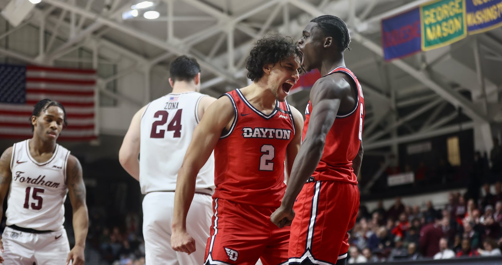 Dayton's Nate Santos, center, reacts after a basket by Enoch Cheeks, right, in the second half against Fordham on Wednesday, Feb. 12, 2025, at Rose Hill Gym in Bronx, N.Y. David Jablonski/Staff