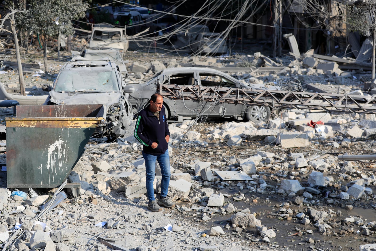 A resident checks the site of an Israeli airstrike in Tyre, southern Lebanon, Saturday, Nov. 9, 2024. (AP Photo/Mohammad Zaatari)