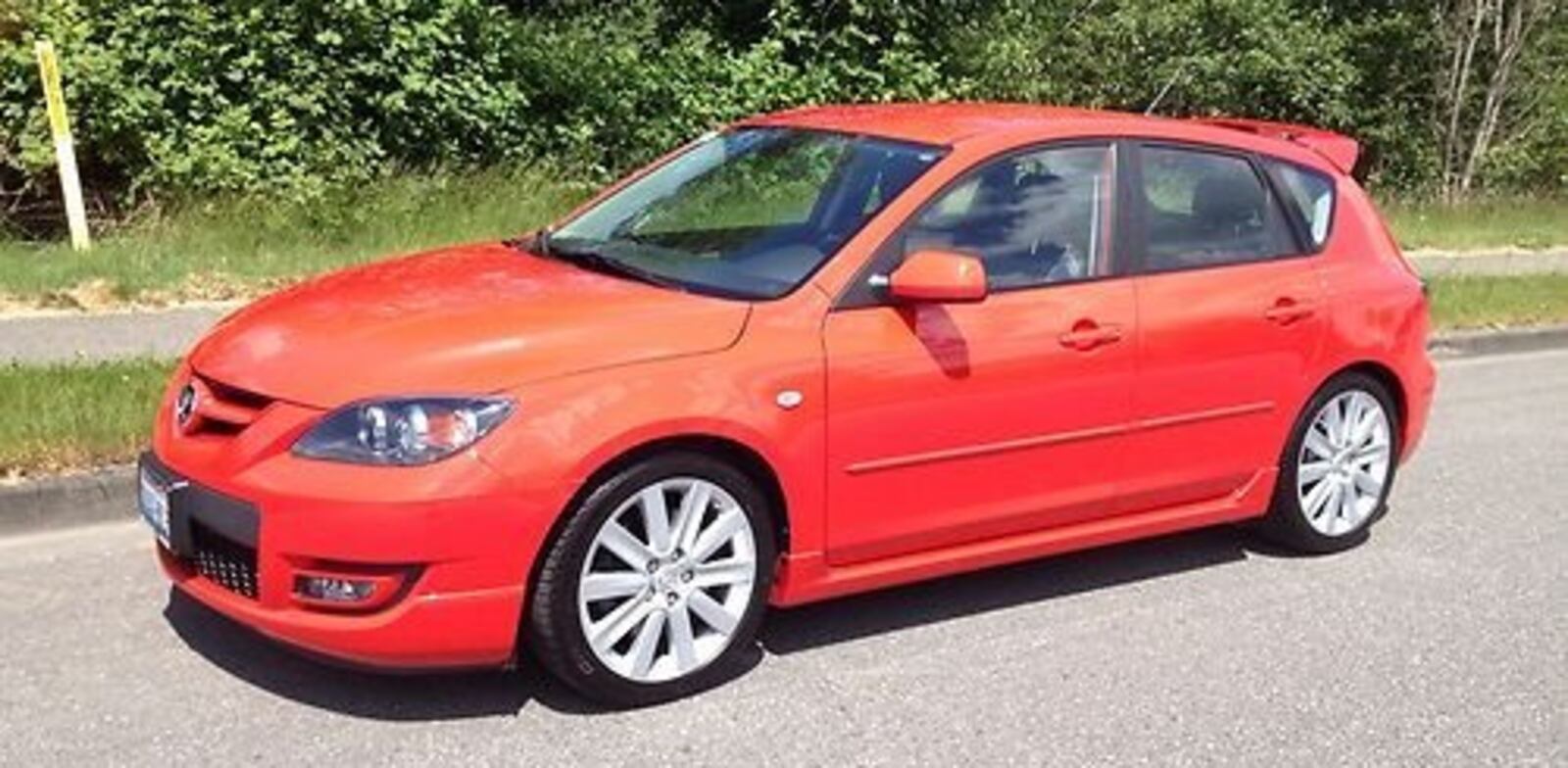 Fong Eng Chew drives a red 2007 Mazda 3 hatchback.